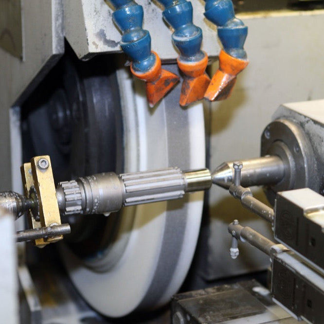 Grinding equipment working on a metal shaft