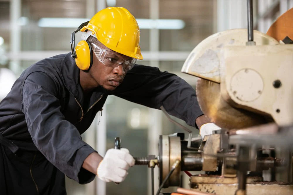 Machinist working with industrial equipment